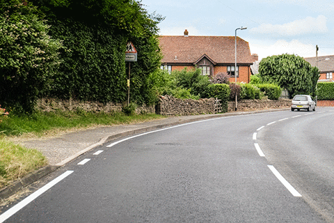 Road and traffic signs - What does the white line along the side of the road indicate?